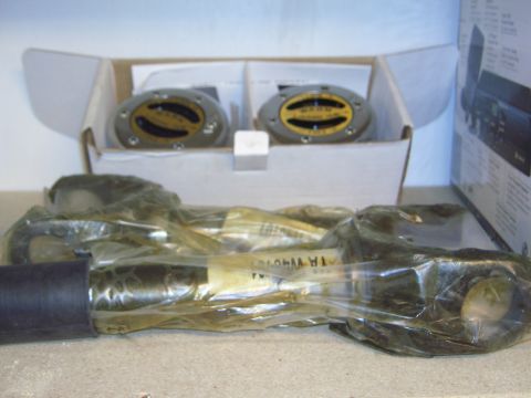 1996 Ford Bronco - Two automotive gauges and parts are packaged for sale on a shelf.