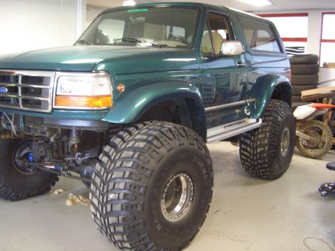 1996 Ford Bronco - This modified Ford Bronco sits high on oversized tires, its lifted suspension and build.