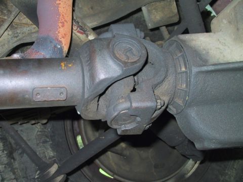1988 Ford Bronco - Close-up view of the driveshaft universal joint on a 1988 Ford Bronco, indicating a need for rebuild.