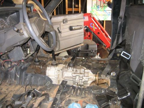 1986 Ford F-150 - The interior of a truck is shown, with the transmission and dashboard exposed, suggesting a work in progress or repair.