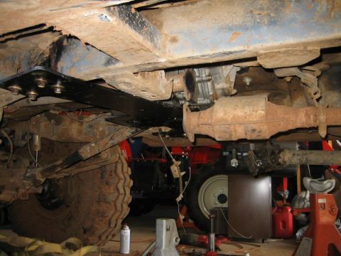 1986 Ford F-150 - The underside of a vehicle is shown, with a focus on the tires and drivetrain components.
