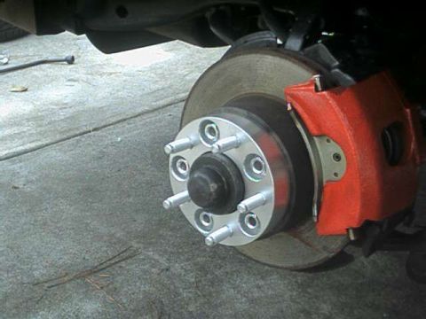 1976 Ford Ranchero - Car brake rotor and caliper assembly shown up close.