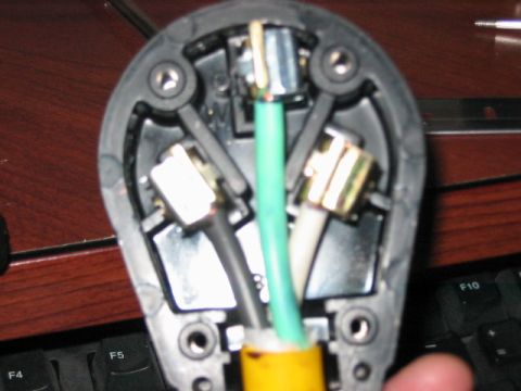 1991 Ford Bronco - The internal wiring of an electrical plug is exposed, revealing the connections for the power cord.