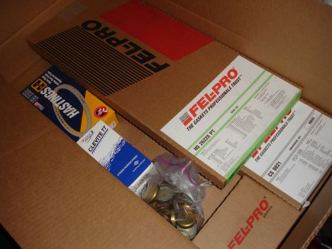 1992 Ford Taurus - A collection of engine gasket sets and parts from brands like Fel-Pro and Hastings are organized within a cardboard box.
