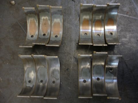 1992 Ford Taurus - Worn engine bearings showing damage to the copper layer, indicating potential engine issues.