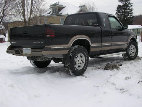 1994 Ford Probe - This black Chevrolet S-10 pickup truck features tan trim and off-road tires, seen parked in a snowy environment.