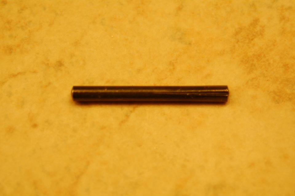metal pin on textured surface, supermotors.net logo at bottom right