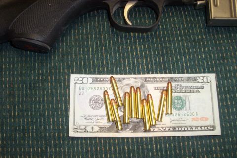 1994 Ford F-150 - A firearm and several rounds of ammunition are displayed on a twenty-dollar bill.
