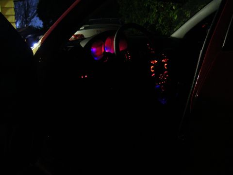 2007 Mazda 3 - Interior view of a car at night, showing illuminated dashboard and controls.