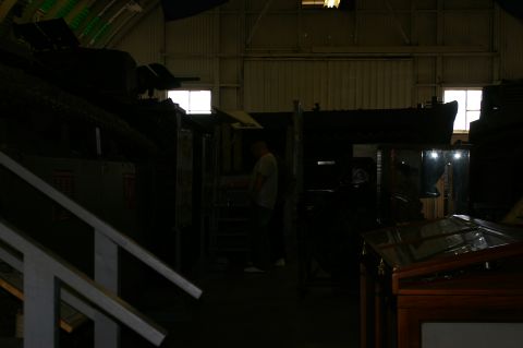1986 Ford Bronco - A dimly lit indoor scene with various displays and a person observing them.
