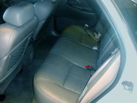 1997 Ford Taurus - The rear seating area of a car, showing the leather upholstery and seatbelt system.