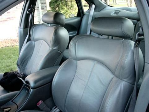 1997 Ford Taurus - The interior of a 1997 Ford Taurus shows gray leather seats and a center console.