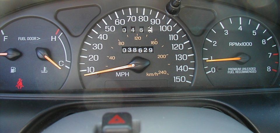 Dashboard gauges with speedometer, tachometer, fuel, and temperature