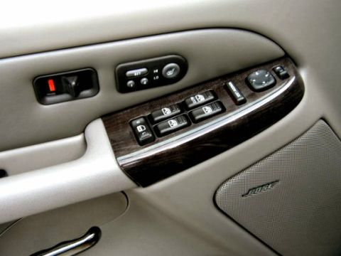 1997 Ford Taurus - The interior door panel of a 2002 GMC Yukon Denali shows wood trim and power controls.