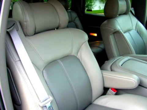 1997 Ford Taurus - The interior features two-tone leather seats with prominent stitching and a visible seatbelt mechanism.