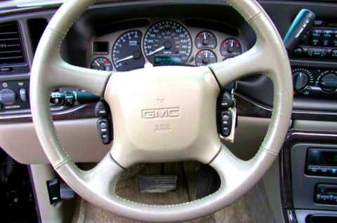 1997 Ford Taurus - Interior view of a GMC vehicle, showing the steering wheel, dashboard, and gauges. The album claim of 1997 Ford Taurus is incorrect.