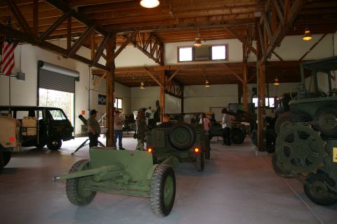 1986 Ford Bronco - Interior view of a museum exhibit various military vehicles and artillery pieces.