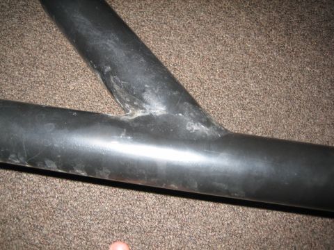 1995 Ford Bronco - Close-up of black roll bar tubing, showing a welded joint and textured surface.