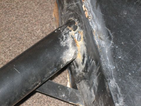 1995 Ford Bronco - Detail of a corroded metal bracket, likely from an automotive component, showing signs of age.