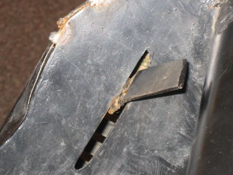1995 Ford Bronco - This image shows a close-up of a damaged and rusted metal component with a visible slot.