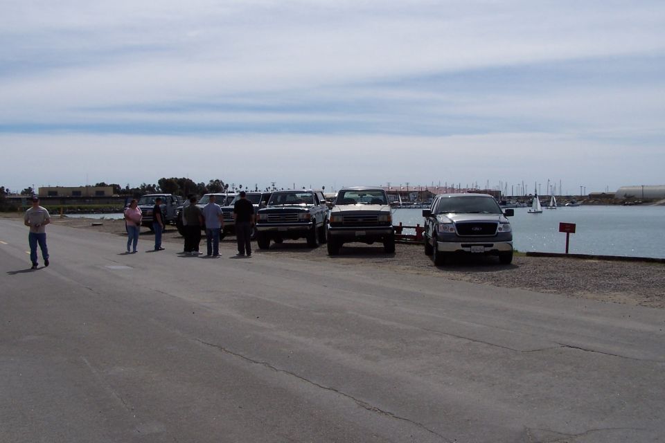 Silver Ford F-150 pickup truck parked by a body of water