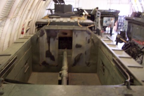 1990 Ford Bronco - The interior of a military vehicle, possibly a tank, is shown with its gun barrel visible.