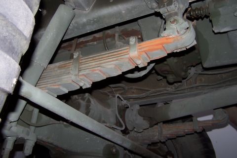 1990 Ford Bronco - Undercarriage detail of a heavy-duty vehicle's suspension system.