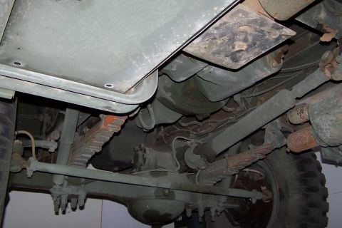 1990 Ford Bronco - The undercarriage of a heavy-duty vehicle reveals its robust suspension and drivetrain components.