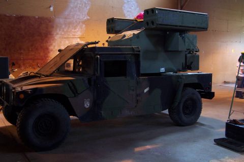 1990 Ford Bronco - This Humvee is equipped with a missile launcher system, suggesting a military or specialized application.