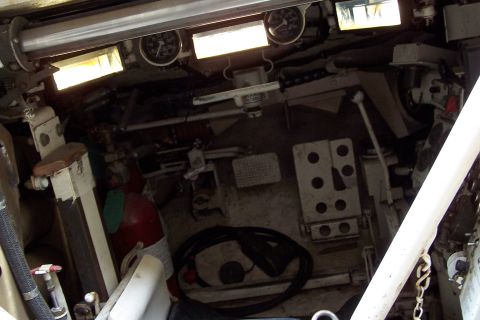 1990 Ford Bronco - The interior of a vehicle shows various controls, gauges, and a fire extinguisher, but no clear year identification is visible.