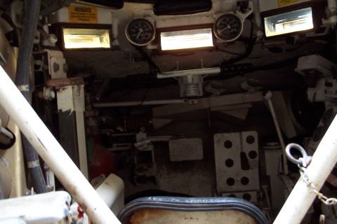 1990 Ford Bronco - The interior of the vehicle shows gauges, warning labels, and various controls.