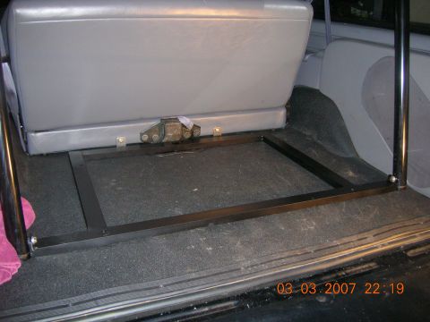 1996 Ford Bronco - The interior of a vehicle shows a rear seat and a metal frame in the cargo area, with a date stamp visible.