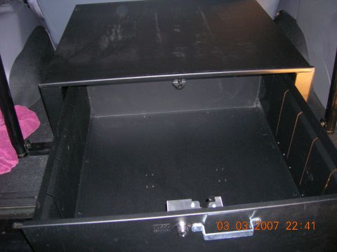 1996 Ford Bronco - The photo shows an empty storage drawer installed in the rear of a vehicle, with a date stamp visible.