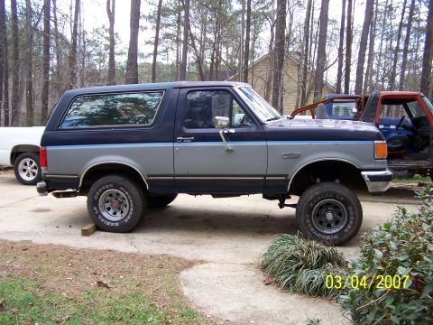 1979 Ford F-150 - A two-tone blue and gray Ford Bronco is parked outdoors next to another vehicle. The date stamp reads 03/04/2007.