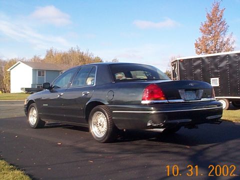 1998 Ford Crown Victoria - Rear view of a 1998 Ford Crown Victoria sedan parked outdoors.