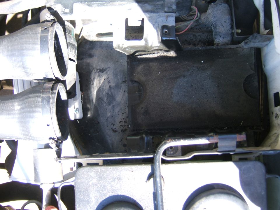 Empty battery tray and engine compartment area with wiring