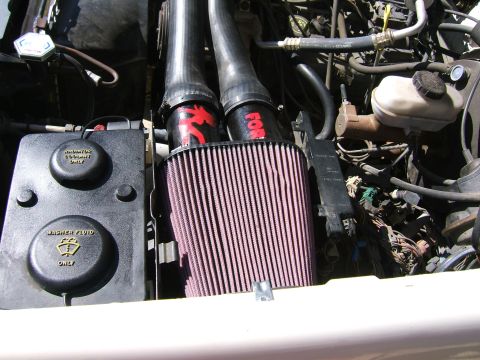 1991 Ford Bronco - Close overhead shot of a K&N FIPK cold-air intake installed in a Ford engine bay, with the large pink pleated cone filter mounted low again…