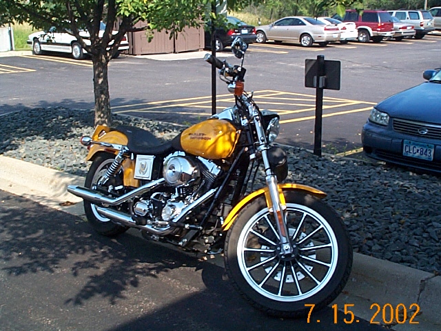 Yellow motorcycle parked on asphalt