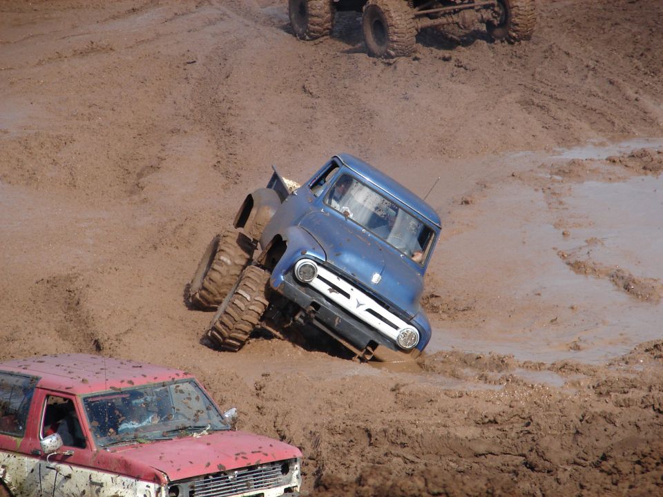 Blue 1956 Ford F-100 stuck in mud, front view