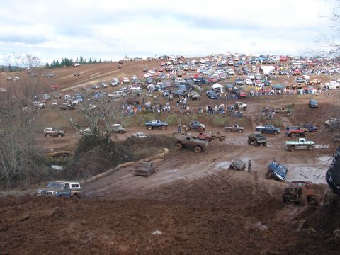 1996 Ford Bronco - Large gathering of off-road vehicles participating in a mudding event.