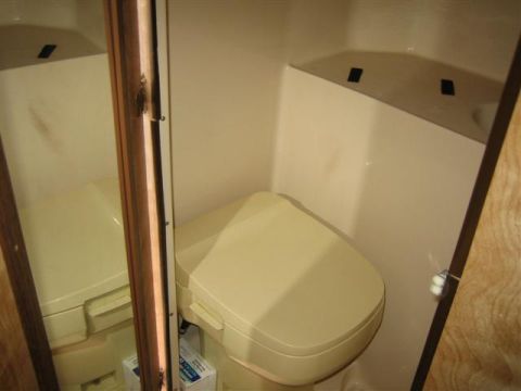 1999 Ford F-250 - Interior view of a camper's bathroom, a toilet and sink.