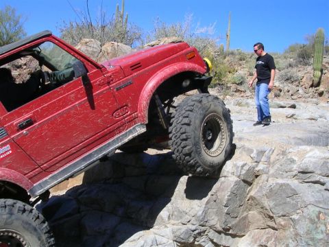 1987 Suzuki Samurai - This modified 1987 Suzuki Samurai navigates a challenging rocky terrain, its off-road capabilities.
