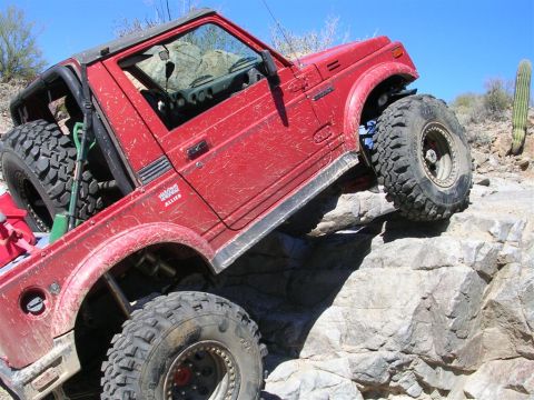 1987 Suzuki Samurai - This Suzuki Samurai is tackling a challenging rocky terrain.