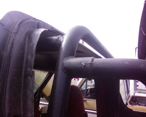 1995 Ford Bronco - The interior of a vehicle is visible, focusing on a custom roll cage structure.