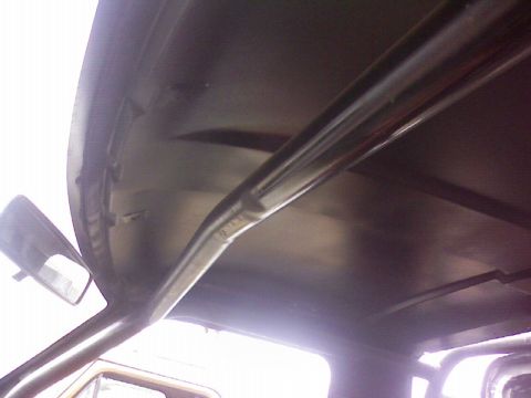 1995 Ford Bronco - Interior shot showing the headliner and a roll bar.