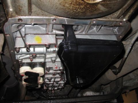 1991 Ford Bronco - Transmission pan and filter assembly with fluid visible.