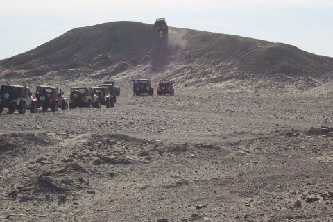 1995 Ford Bronco - A group of Jeeps navigates a challenging off-road course on a steep, rocky incline.