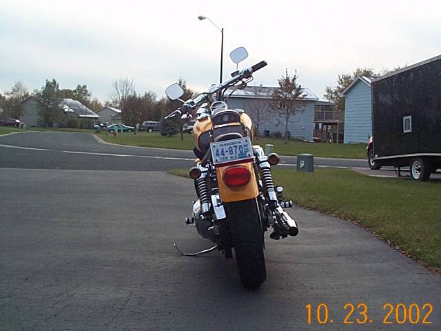 Rear view of a yellow motorcycle with a license plate reading 44-8705