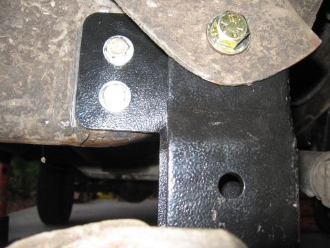 1974 Ford F-100 - A close-up view of a custom bracket attached to the vehicle's frame, secured with bolts.