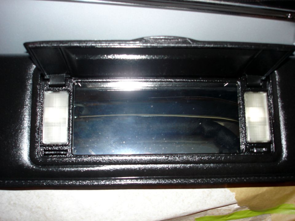 Black sun visor with illuminated vanity mirror, interior view